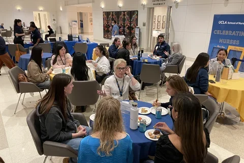 UCLA Nursing students speaking with a clinician at the 2024 Bruin Nurse Networking Night